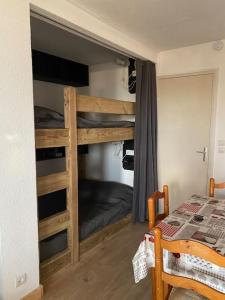 Ce lit superposé se trouve dans un dortoir doté d'un lit et de lits superposés. dans l'établissement Charmant studio cabine 26m² avec belle terrasse, à Font-Romeu-Odeillo-Via