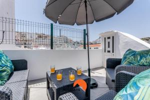 a patio with a table with glasses of orange juice at #183 Private Terrace Oldtown with AC in Albufeira