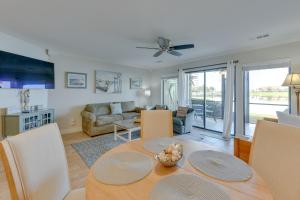 a dining room and living room with a table and chairs at Stewart House in the Beautiful SeaScape Resort in Destin