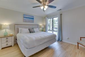 a bedroom with a bed and a ceiling fan at Stewart House in the Beautiful SeaScape Resort in Destin +24 photos