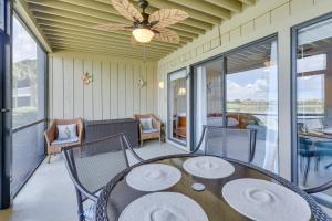a patio with a table and chairs on a porch at Stewart House in the Beautiful SeaScape Resort in Destin