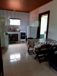 a large kitchen with a table and appliances at Casa Lumiar in Lumiar