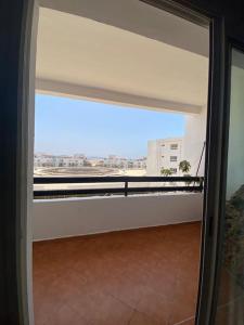 an open door to a balcony in a building at Marina Agadir Comfy Apartment in Agadir
