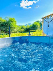 a large pool of water with a water slide at Villa 84 & Apartments Jacuzzi & Sauna in Zakopane