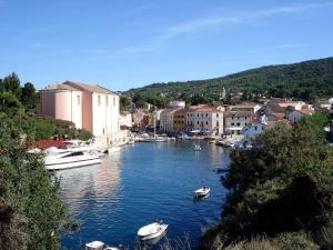 a group of boats in a river in a town at Apartments Velo in Veli Lošinj