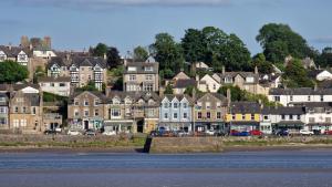 a group of houses on a hill next to the water at Carr Garth in Arnside