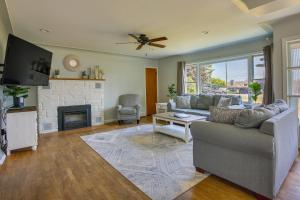 a living room with a couch and a fireplace at Traverse City Home with Fire Pit, Patio and Yard! in Traverse City