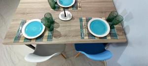 a table with blue bowls and plates on it at Perivolia Serenity in Chania in Ayiá
