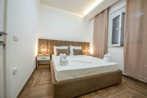 a bedroom with a large bed with white sheets at Twins Apartment in Ulcinj