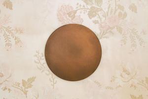 a brown egg on a wall with floral wallpaper at Hotel Beau Séjour Lucerne in Luzern