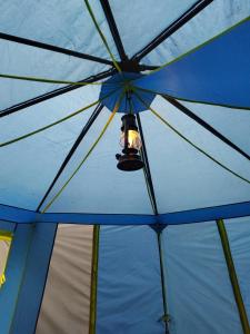 a blue umbrella with a light hanging from it at Puumaja maaseudulla in Tuorila