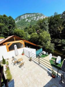 a patio with chairs and a view of a mountain at Casa Anca in Băile Herculane