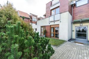 una casa con un patio con árboles frente a ella en Apartament 20 metrów od plaży - Gdańsk Brzeźno en Gdansk