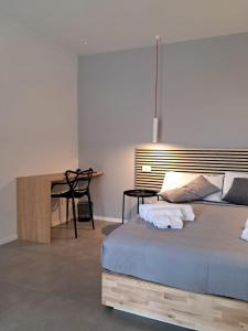 a bedroom with a bed and a table with chairs at Porta San Paolo House in Castelbuono