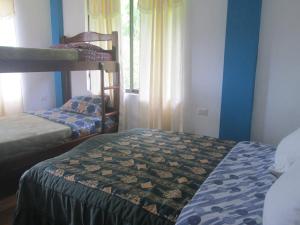a room with two bunk beds and a window at CASA MARTIN en Baños de Agua Santa in Baños