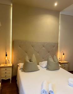 a bedroom with a large white bed with two pillows at Soggiorno Pezzati in Florence