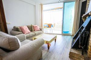 a living room with two couches and a fireplace at Bello Horizonte ONLY FAMILIES in Salou