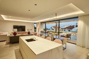 a kitchen and living room with a view of the ocean at Sea Gardens Villa in Nerja