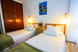 two beds in a hotel room with at Bello Horizonte ONLY FAMILIES in Salou