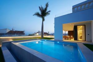 a swimming pool in the backyard of a house at Sea Gardens Villa in Nerja