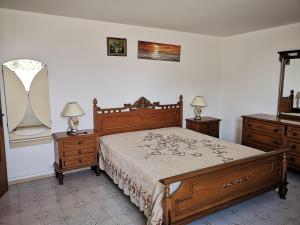 a bedroom with a bed with two dressers and two lamps at Rivabella Economy 2 in Gallipoli