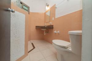 a bathroom with a toilet and a sink at Hotel La Trigueña in Isla Mujeres