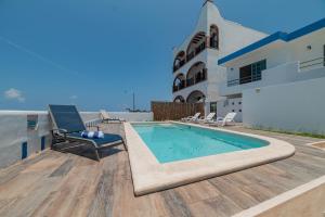 a swimming pool on the roof of a house at Hotel La Trigueña in Isla Mujeres