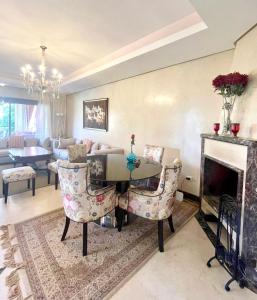 a living room with a table and chairs and a fireplace at Dar Marrakech in Marrakech