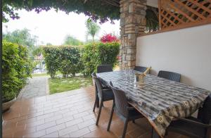 a table and chairs sitting on a patio at DONNA FILOMENA Residence in Marina di Camerota