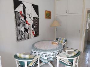 a dining room with a table and two chairs at Whole house Ariela, 20m to the beach, has a barbecue, 2 terraces in Šibenik