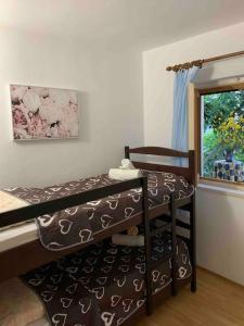 a room with a bunk bed and a window at Whole house Ariela, 20m to the beach, has a barbecue, 2 terraces in Šibenik
