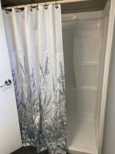 a shower curtain in a bathroom with a showeroser at Moonlite Retreat- Waterfront home in Welaka, Florida in Welaka