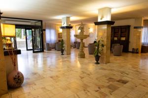 a lobby with a tile floor and a fountain at Hotel Park Ge.Al. in Città di Castello