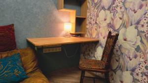 a room with a desk and a chair and a lamp at City Center Van Gogh Suite in Tbilisi City