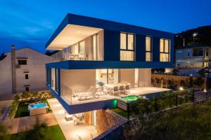 a house with a blue facade at night at D HOUSE in Stara Novalja