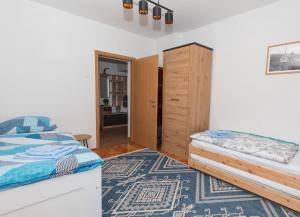 a bedroom with a bed and a wooden cabinet at Lynx and Fox apartment in Delnice