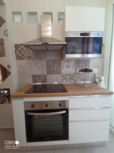 a kitchen with a stove and a sink at Civico 6 in Peschiera del Garda