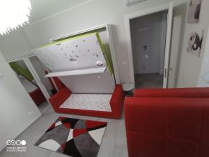 a living room with a red couch and an open box at Civico 6 in Peschiera del Garda