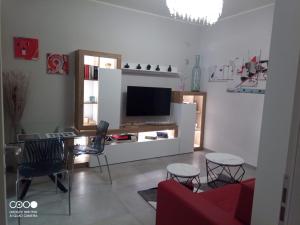 a living room with a tv and a table and chairs at Civico 6 in Peschiera del Garda