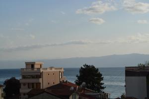 a building with the ocean in the background at Luxe Apartment in Ohrid