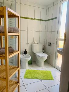 a small bathroom with a toilet and a sink at El cortijo Bungalow Playa las Americas in Playa de las Americas