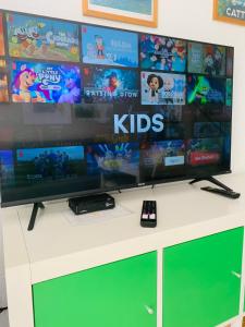 a flat screen tv sitting on top of a white cabinet at El cortijo Bungalow Playa las Americas in Playa de las Americas