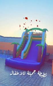 a inflatable slide on the beach with the ocean in the background at شاليةالخفجي in Al Khafji