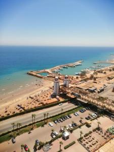 an aerial view of a beach and the ocean at Regency Porto pyramids in Ain Sokhna