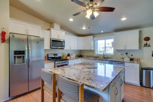 a kitchen with white cabinets and a granite counter top at Spacious Vacation Home 5 Mi to Ridgway State Park in Ridgway