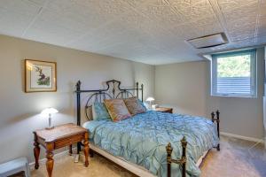 a bedroom with a bed with a blue comforter at Spacious Vacation Home 5 Mi to Ridgway State Park in Ridgway