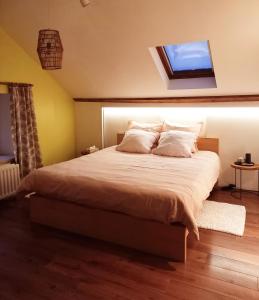 a bedroom with a large bed with a window at Le Wayai in Sart-lez-Spa