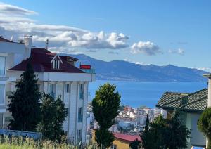 a building with a view of the water and mountains at TRABZON PANORAMA APART in Trabzon