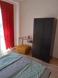 een slaapkamer met een bed, een kast en een raam bij Welcome to Daisy sunny place! in Varna