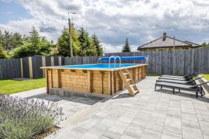 a pool in a backyard with a bench and a table at SpaceroVa in Nadole